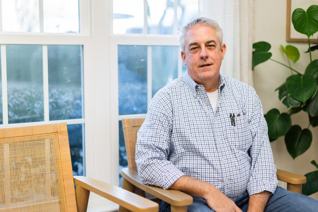 Professional headshot of Dr. Cooper with a confident and approachable expression in a clinical setting